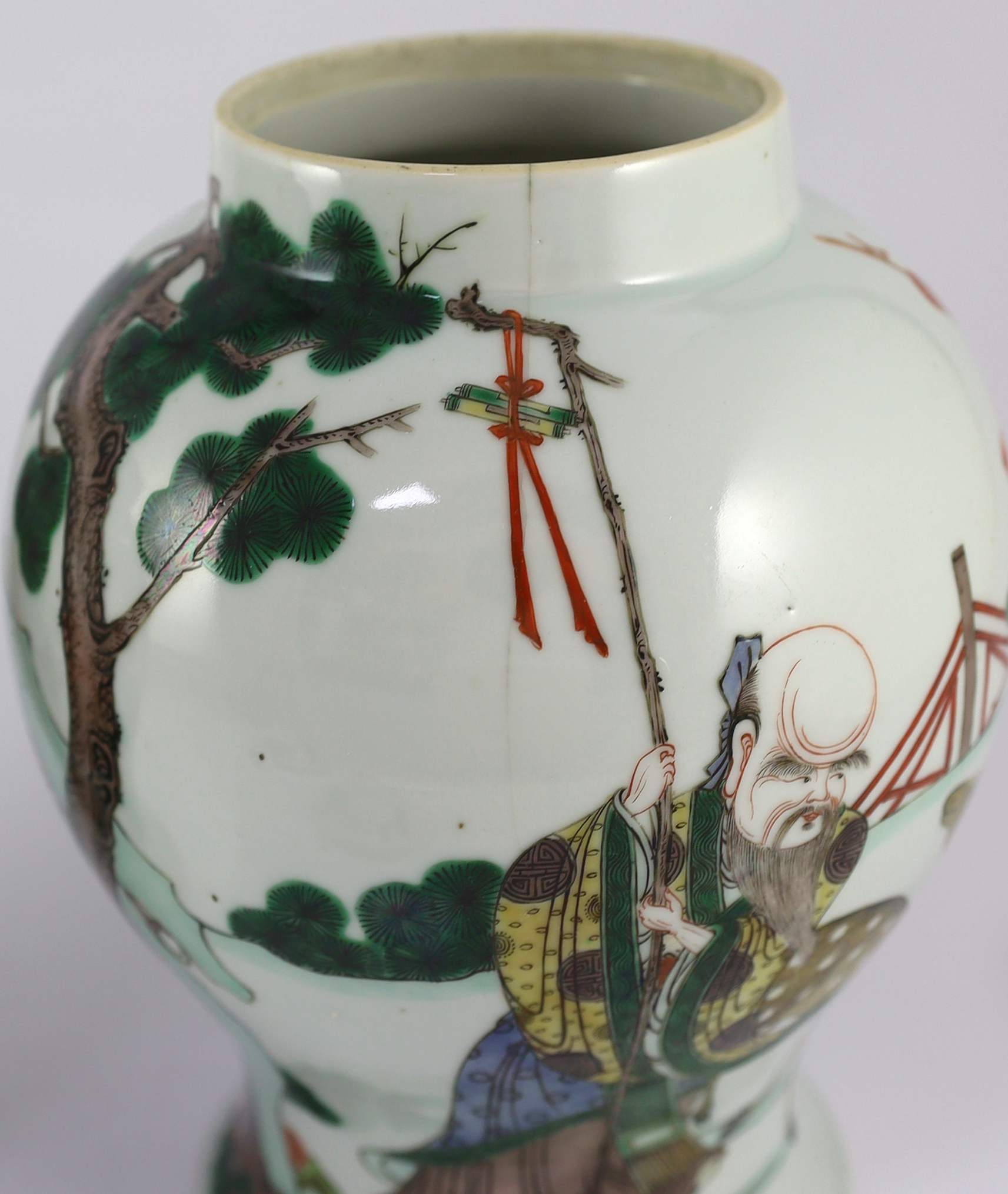 A pair of Chinese famille verte ‘Sanxing’ vases and covers, 19th century, some cracks